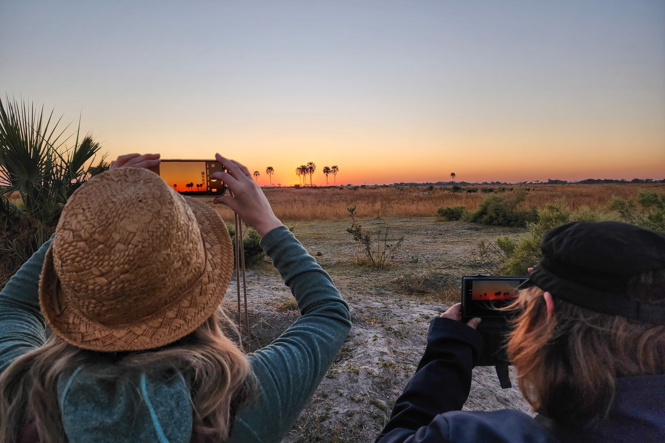Sunway Safaris Botswana Okavango Delta on morning walk clients taking picture of sunrise Patrick Fonseca